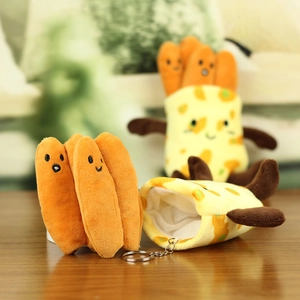 Close-up of a creative plush pancake keychain with cute embroidery on wooden background