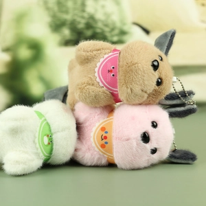 Close-up of cute plush dog keychains with colorful scarves and soft fur texture