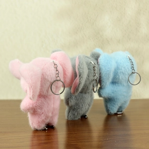 Three plush elephant keychains in pink, grey and blue with soft faux fur and metal rings