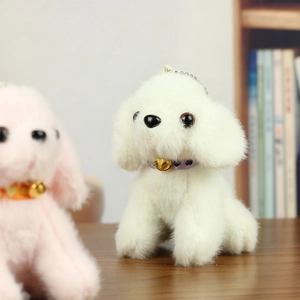 Close-up of cute plush dog keychains with colorful heart ties and gold bells