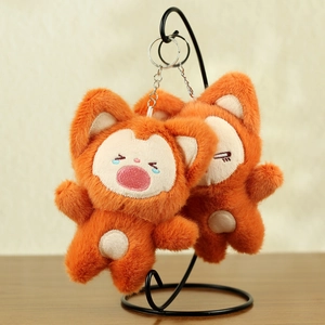 Close-up of cute plush fox pendants with embroidery and silver metal keychains