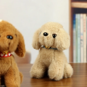 Close-up of curly plush teddy dog keychain with a blue collar and golden bell detail