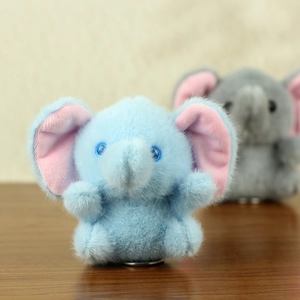 Close-up of blue plush elephant keychain with pink inner ears and soft texture detail