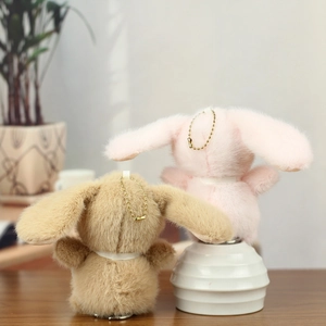 Plush bunny keychains in khaki and pink featuring soft faux fur and gold bead chains