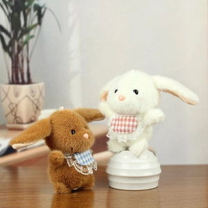 Close-up of cute plush rabbits with lace bibs and soft fur texture for bag charms