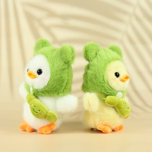 Plush duck keychains in white and yellow wearing green frog hats and crossbody bags