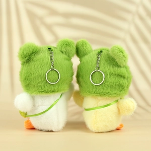 Pair of cute plush duck keychain charms with frog hats in white and yellow colors