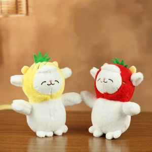 Cute plush sheep dolls with pineapple and strawberry hats on a natural wooden surface