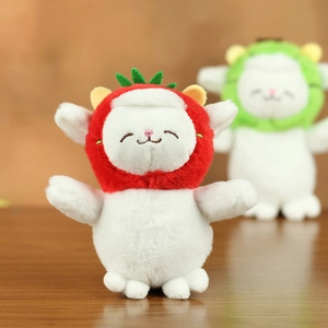 Close-up of plush sheep keychain with cute strawberry hood and soft white wool texture