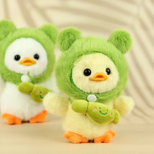 Close-up of cute plush ducklings in green frog hoodies with fish bags and soft texture