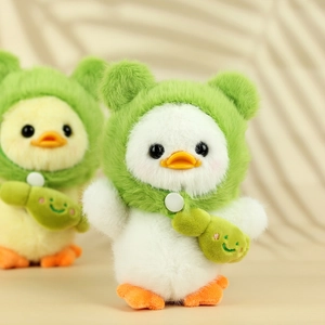 Close-up of cute plush ducks wearing green frog hoodies and small crossbody bags