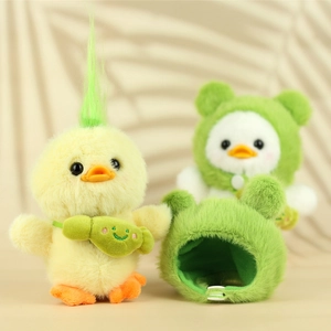 Detail of yellow plush duck with removable green frog headband and accessories