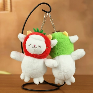 Detail of plush lamb keychains with strawberry and green fruit hats on a metal display