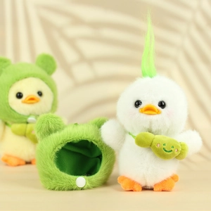Detail of plush duck toy with removable green frog hat and matching crossbody bag