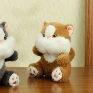 Detail shot of cute brown plush cat toy showing soft fabric and pink paw embroidery