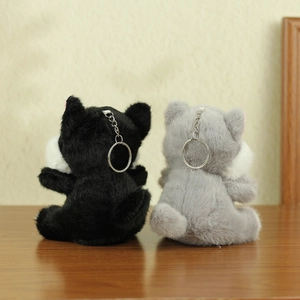 Back view of fluffy grey and black plush cat keychains with silver metal rings