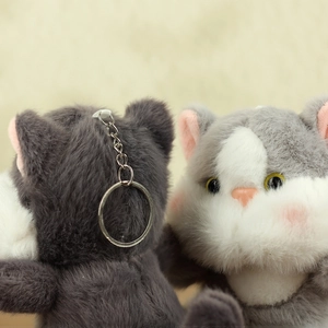 Detailed view of fluffy grey and white cat plush keychain with soft fur and metal ring