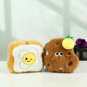 Close-up of plush toast and cookie keychain charms with soft textures and cute expressions