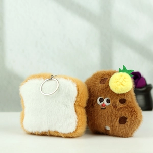 Close-up of plush toast and brown cartoon character keychains with embroidery