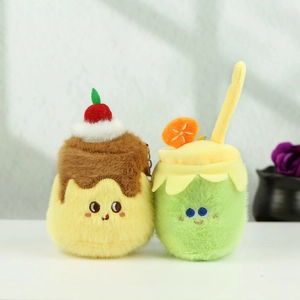 Plush pudding cake and green soda drink keychains with cute faces on a white surface