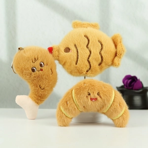 Detail of plush food keychains including drumstick and croissant with cute faces