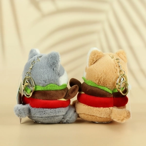 Close-up of plush cat shark pendants with burger design and gold metal keychains