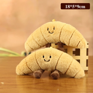 Cute croissant plush toy set with smiling face and brown limbs for bag decoration