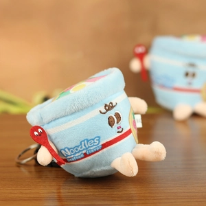 Detailed close-up of seafood cup noodle plush pendant with cute cartoon expression