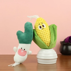Cute plush corn and green onion pendants with embroidered faces on pink background
