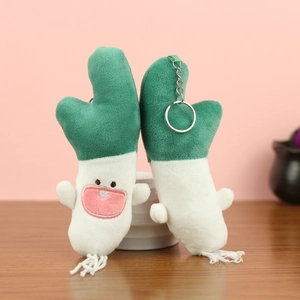 Close-up of cute plush green onion pendants with cartoon faces and metal keychains