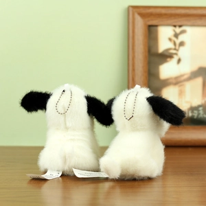 Detail shot of cute plush puppy keychains with black ears and silver metal bead chains