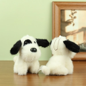Close-up of plush spotted puppy charm with soft faux fur and silver metal ball chain