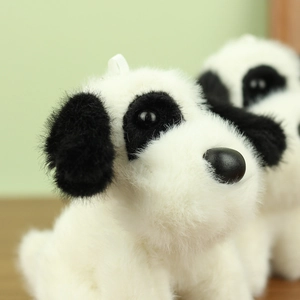 Close-up of the fluffy white plush dog keychain with black nose and soft fur detail