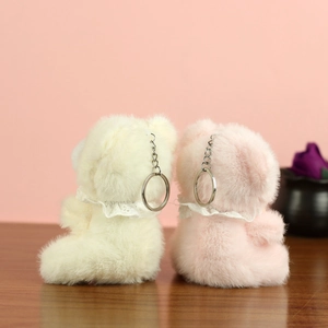 Detail of plush teddy bear charms with soft fur, lace collars, and silver keychains