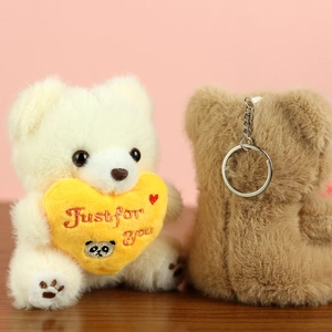 Detail of plush bear keychain showing soft fur texture and silver metal ring attachment