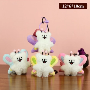 Plush bee-dog pendants in four colors with butterfly wings on a dark wood background