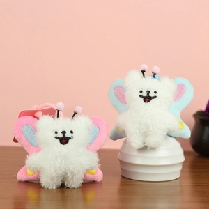 Cute plush bee puppy keychain with fluffy white fur and pink or blue butterfly wings