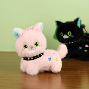 Detail of plush pink cat charm with colorful embroidery and a punk-style rivet collar