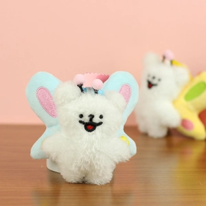 Close-up of cute plush bear pendant featuring blue butterfly wings and pink antennae