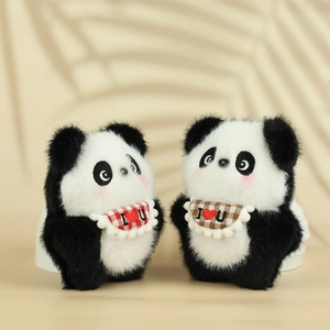 Detail of plush panda keychains with red and brown checkered bibs and hearts