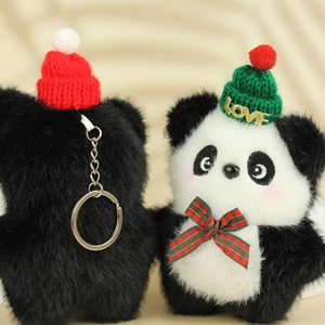 Detail of plush panda keychains with mini knitted hats and festive plaid bows on metal rings
