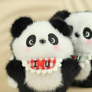 Macro view of plush panda keychains with red checkered I Love You bibs and soft fur