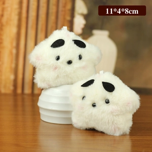 Cute white plush star toy keychain set with soft fur texture on a wooden desk