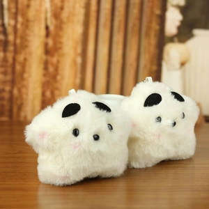 Close-up of soft plush star pendants with cute faces on natural wooden background