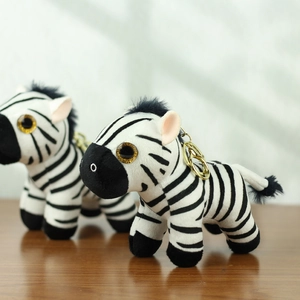 Detail eines Zebra-Plüschanhängers mit schwarz-weißen Streifen und goldenem Schlüsselring
