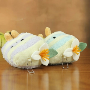 Detail of plush cake keychain pendants in purple and blue stripes with floral accents