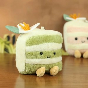 Detail of plush cake keychain featuring soft fur with a cute smiling face and flower