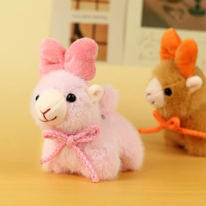 Close-up of pink plush alpaca keychain with fluffy bow and soft texture details