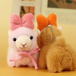 Front and back detail of cute pink and brown alpaca plush keychains with bows