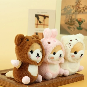 Three cute plush Shiba Inu dogs dressed in bear, rabbit, and cat outfits on wooden tray